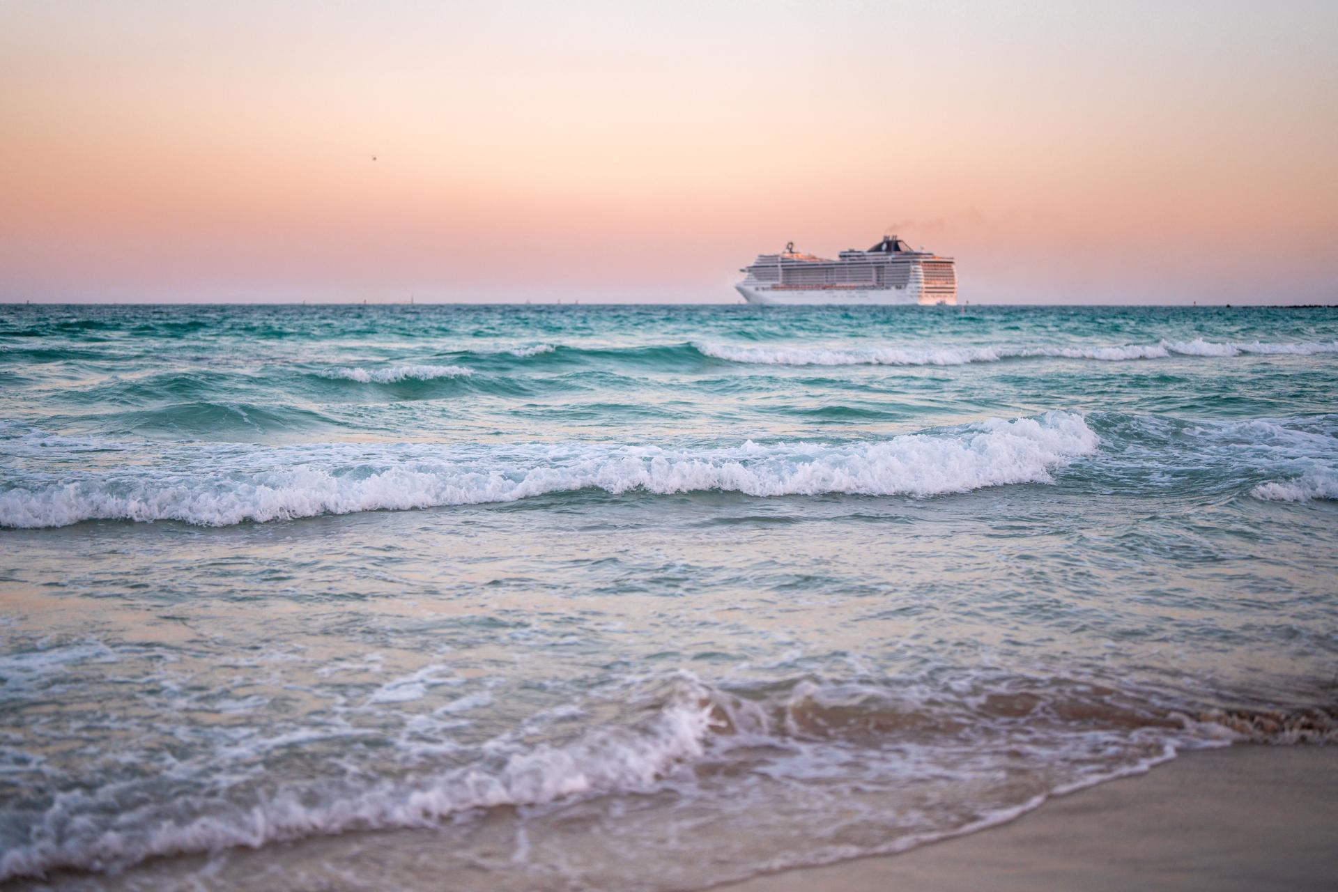 Cruise ship on the ocean. Luxury liner at sea. Miami Beach with cruise ship. Sea water and cruise liner. Tourist cruise ship near coast. Ocean waves and vessel boat. Summer dream vacation. Boat trip.